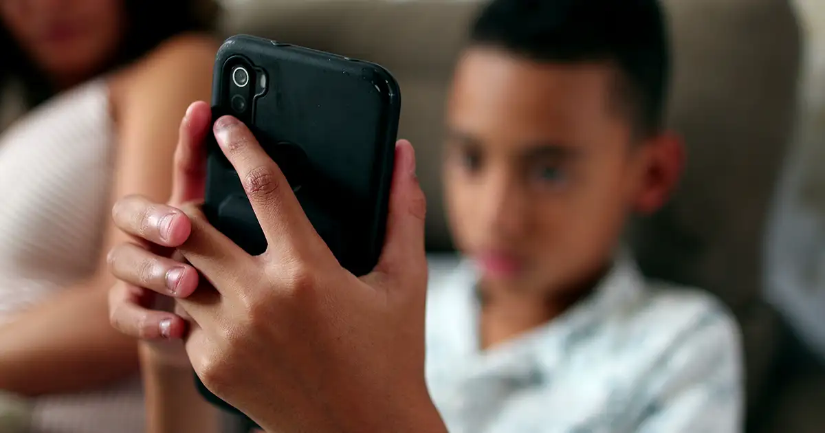 Child playing mobile phone game.