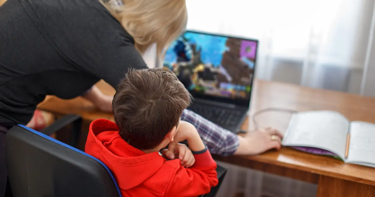 Mother turning off computer used by child playing Roblox
